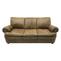 Contemporary three-seat sofa, upholstered in stitched brown leather with brass studwork decoration, rolled back and arms, raised on turned supports