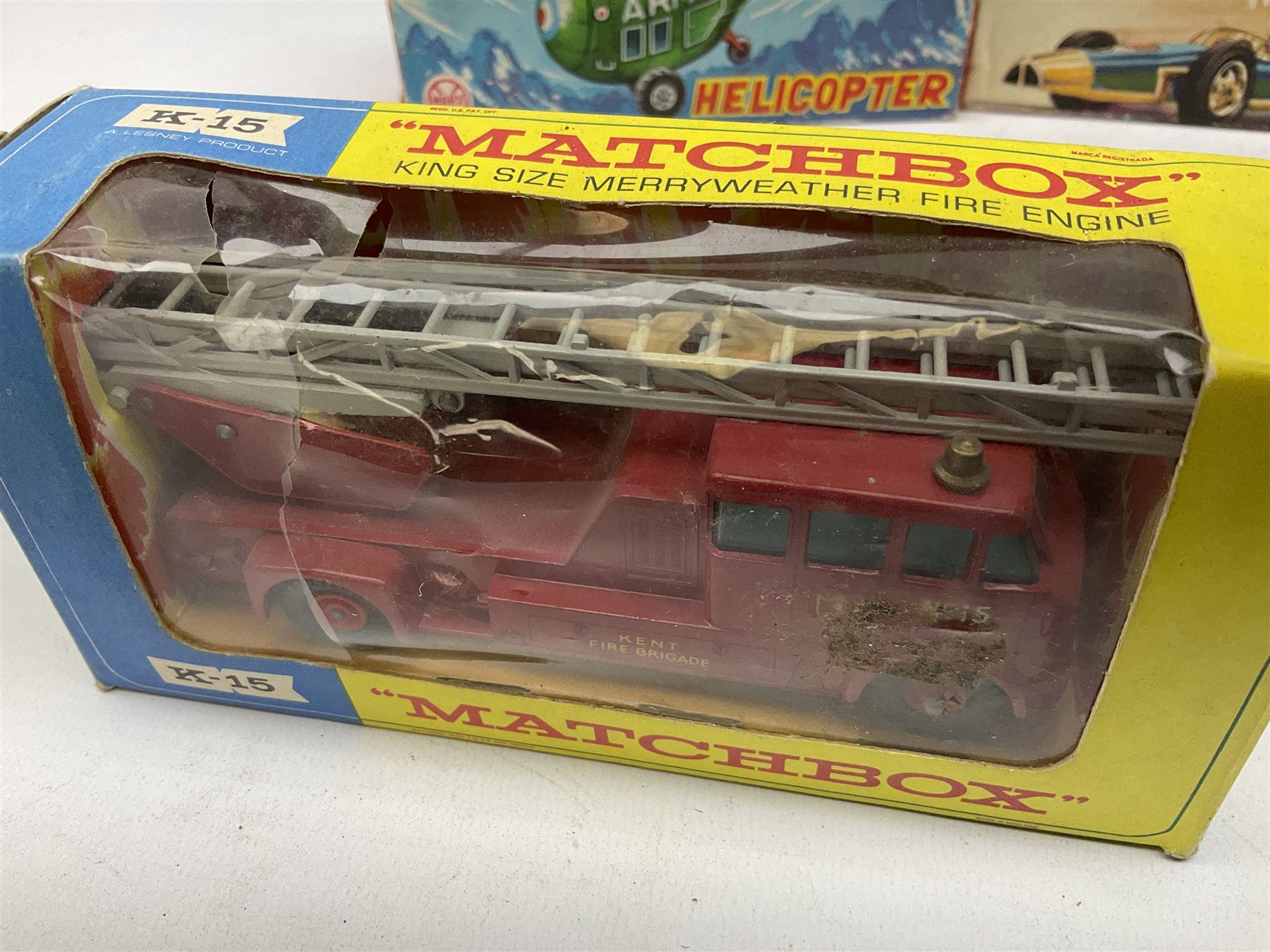 Various makers - Tri-ang Mini-Hi-Way Racing Car Series Le Mans No.9 racing car; Matchbox K-15 Merryweather Fire-Engine; Marx tin-plate Friction Helicopter; all boxed; and a Minic Motor Rally Adventure box containing a Jaguar Police car for spares or repair (4)