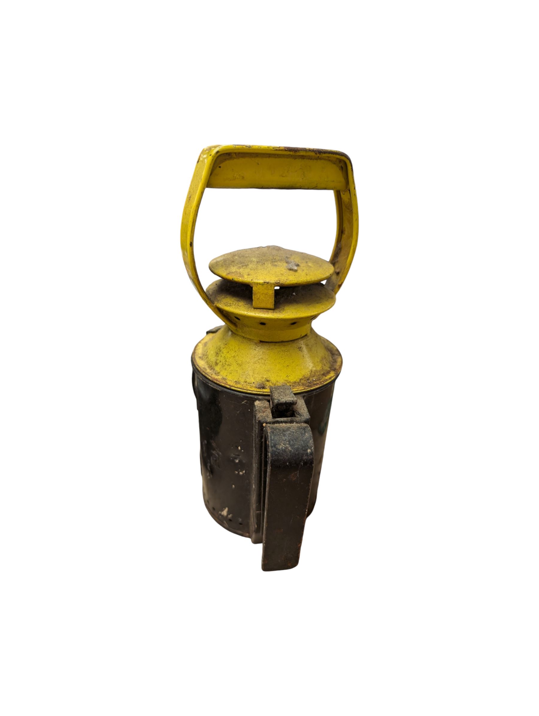 Three British Railway Bardic lamps, an enamel shunting signal disc and a yellow and black signal lamp