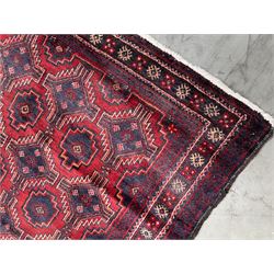 Baluchi rug, red and blue ground with repeating geometric design, the guarded border decorated with stylised motifs