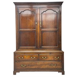 George III oak livery cupboard, projecting moulded cornice over two panelled doors, the upper panels within stepped ogee and arched moulded frame, the interior fitted with a single row of wooden hooks, two short and one long drawers, on bracket and return skirted base 