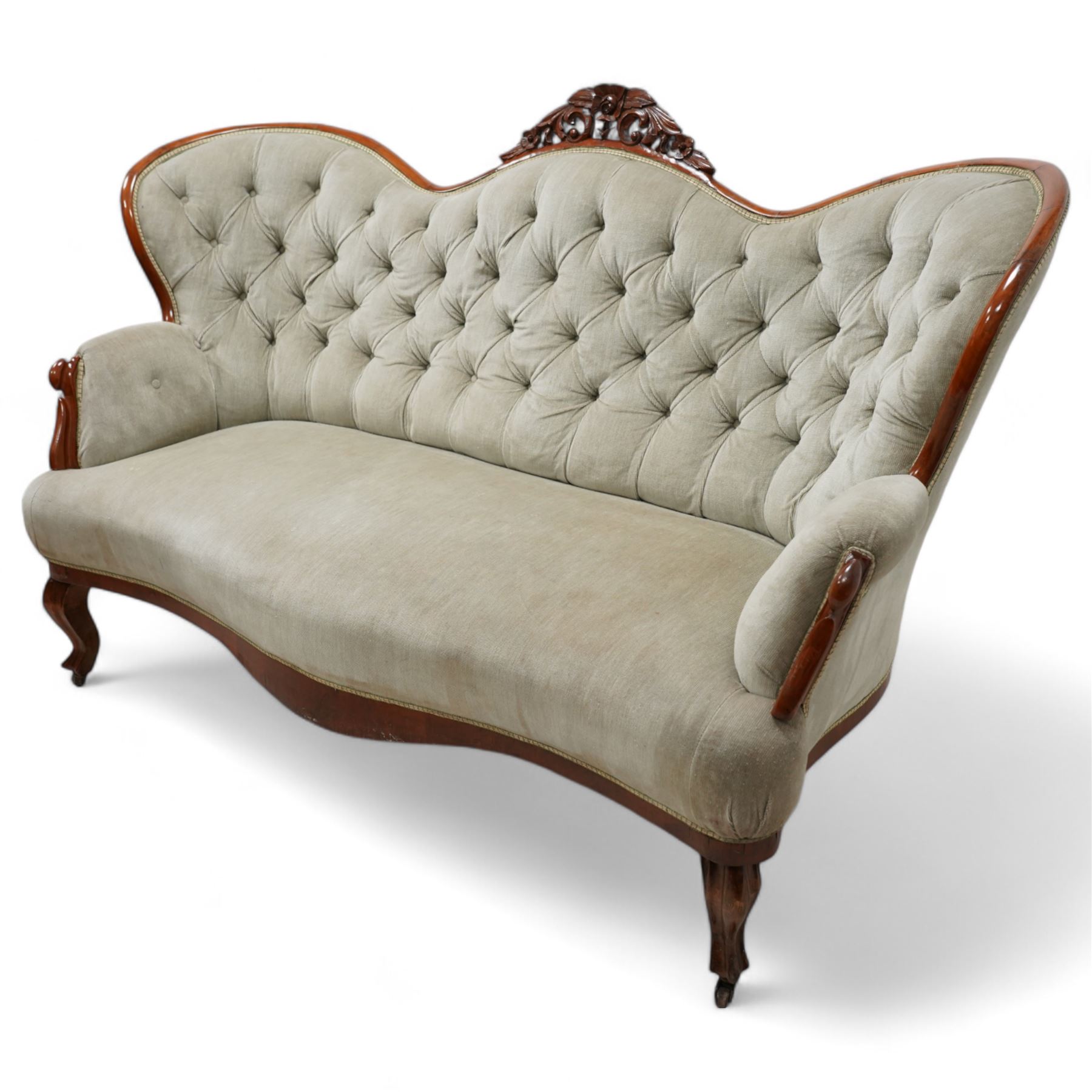 Victorian walnut double-ended settee, shaped cresting rail with foliate carved pediment, upholstered in buttoned sage green fabric, on cabriole feet