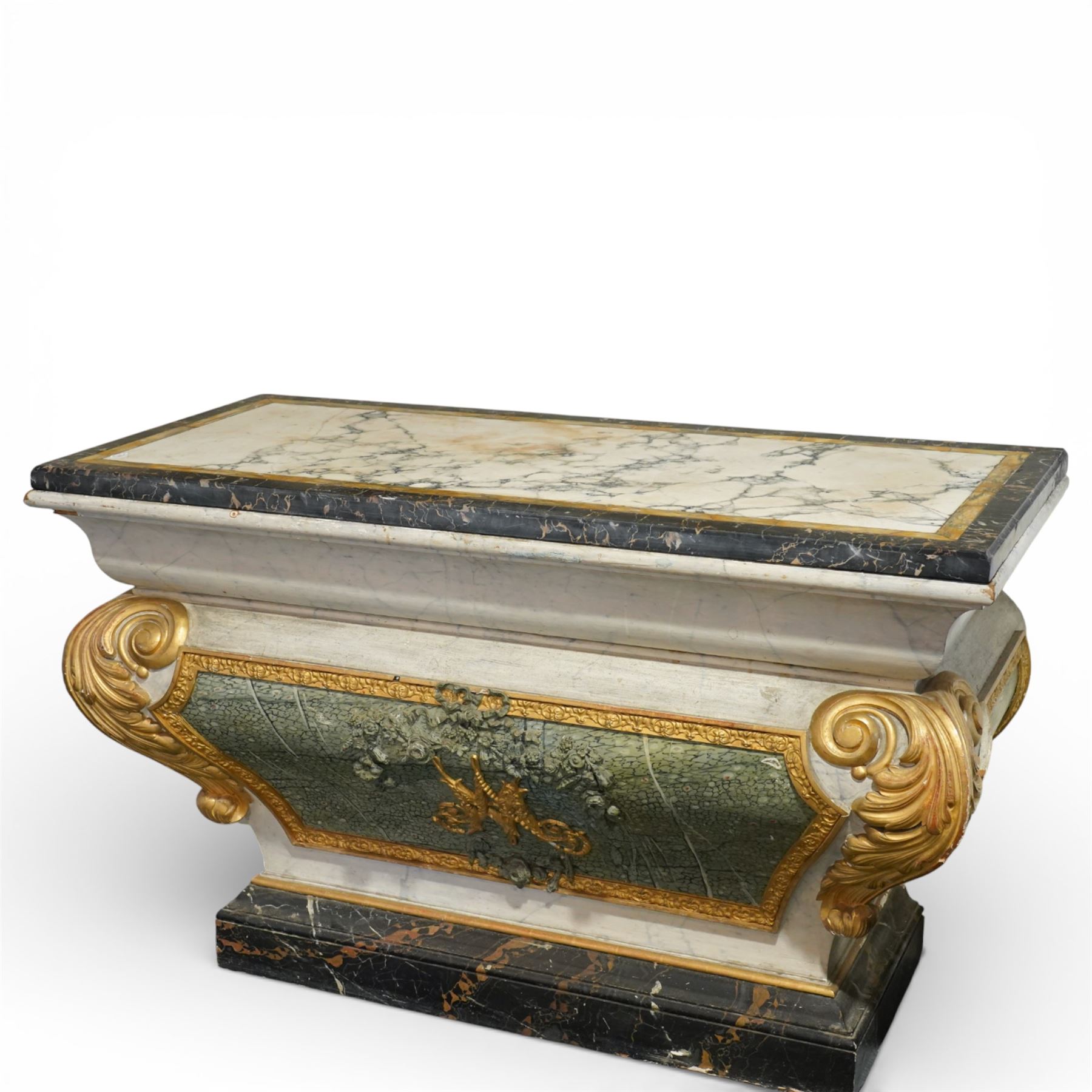 A 20th century Italian Neoclassical console table of architectural pedestal form, inspired by Roman architectural prototypes, with marble top and simulated marble scagliola-type finish; the rectangular marble top with grey veining within a black and yellow marble border, above a pedestal base finished in a finely executed faux-marble surface and enriched with parcel-gilt scrolling acanthus terminals, floral garlands, a central ribbon-tied motif in relief, and further raised flowerheads and a central gilt monogram, terminating in a stepped plinth base