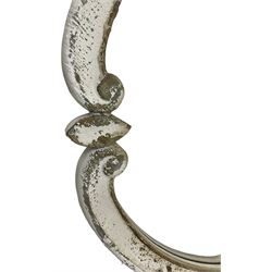 French design carved pine wall mirror, the frame in the form of conforming c-scrolls, plain mirror plate, in distressed white paint finish 