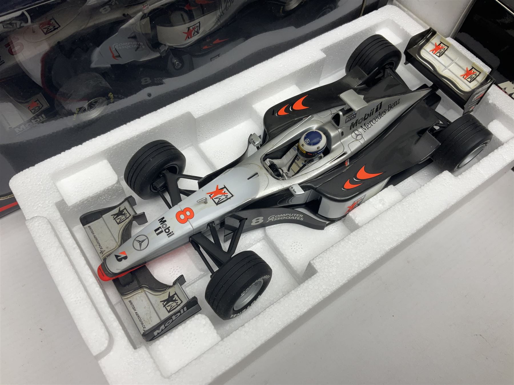 Four Minichamps 1:18 scale die-cast racing cars - Williams F1 Team BMW FW26 R. Schumacher; McLaren Mercedes MP4-12 D. Coulthard; McLaren Mercedes MP4-13 M. Hakkinen; and Formel 1 Jordan peugeot EJR 195 E. Irvine; all boxed (4)