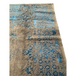 Large Persian grey stone and luminous blue ground carpet, decorated indistinctly with faded floral and scrolling patterns, central oval medallion decorated with scrolling foliage band