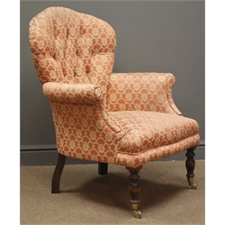  Early 20th century armchair, shaped back, deeply buttoned with floral patterned fabric, turned supports, W77cm  