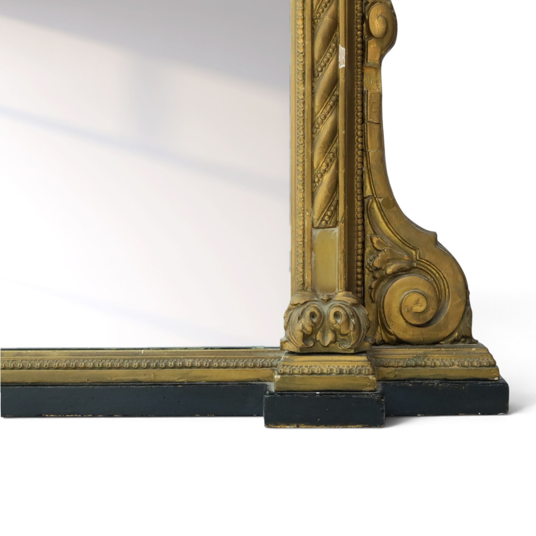 Large late 19th century gilt framed overmantel mirror, urn pediment above a foliate and Greek key frieze, egg and dart beaded edges, enclosing a plain mirror plate, with scrolled lower sections