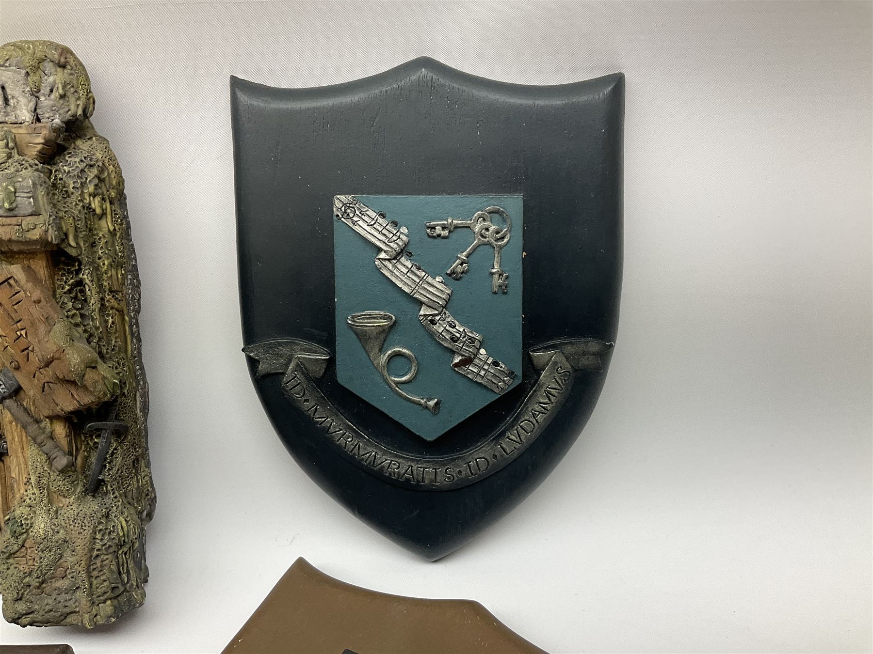 Terry Pratchett Discworld plaques, designed by Clarecraft, comprising 'the First Discworld Event Clarecraft August 95', the collectors guild joining shield, the fools guild DW99C, the seamstresses guild DW98C, the musicians guild DW00C together with 'Door of the mended drum' wall hanging DW17. 