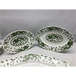 Set of eleven early 20th century Limoges for Green & Abbott of Oxford Street plates, decorated in the chinoiserie style with green dragons upon white ground, together with three further oval serving dishes to include a large twin handled example, all with red printed marks beneath
