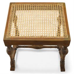 Two upholstered and caned footstools, a late Victorian carved mahogany footstool, oval form upholstered in geometric kilim-style fabric, on cabriole supports (H 27cm, W 56cm, D 47cm), together with a 20th century beech stool, square caned seat on turned supports united by stretchers (H 43cm, W 44cm, D 37cm)