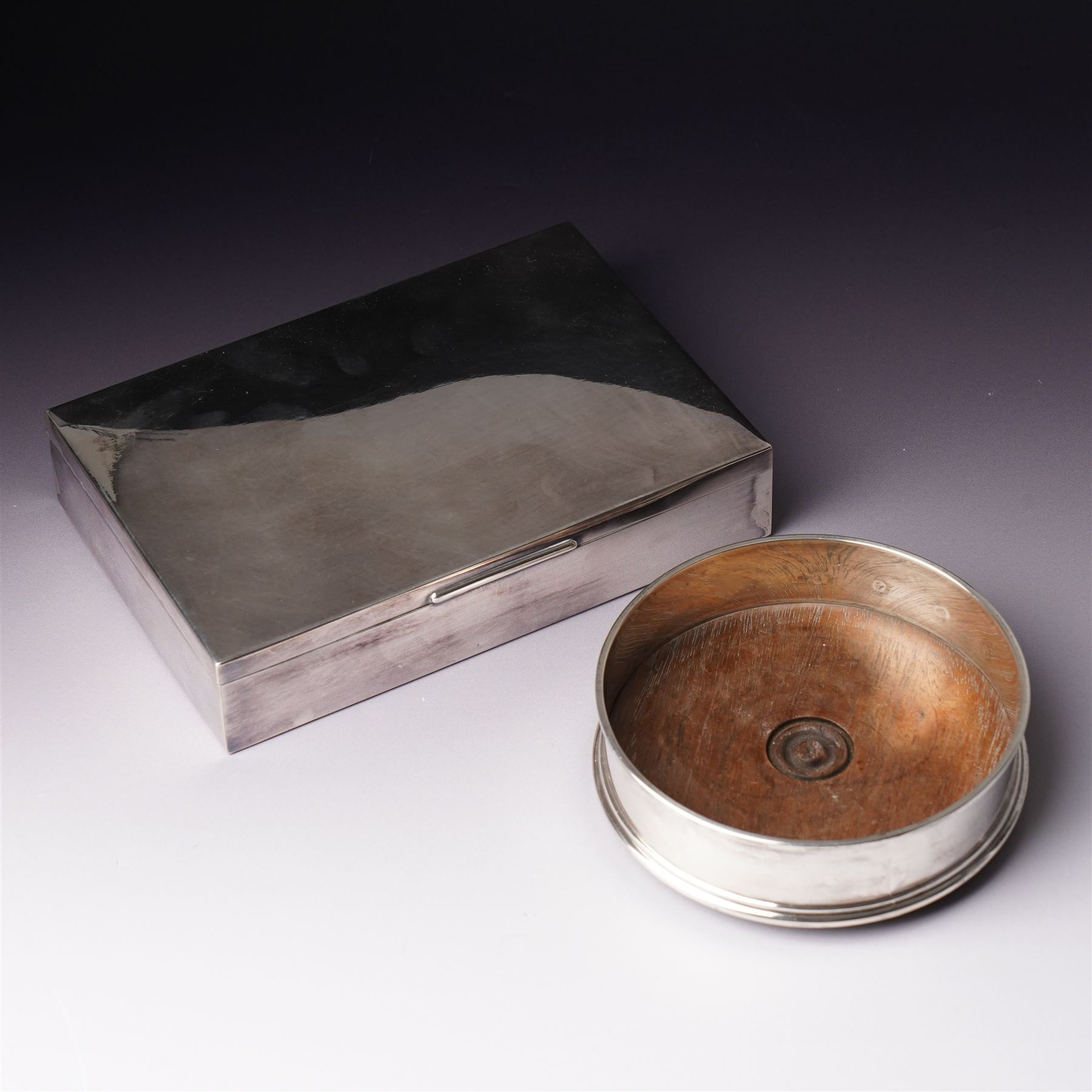 German 925 standard silver cigarette box with hinged lid  and a silver bottle coaster with turned wood base London 1986 Maker M C Hersey & Son