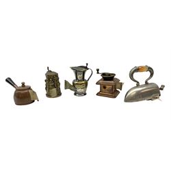 Brass and copper novelty tape measure in the form of a coffee grinder, together with four other examples in the form of an iron, saucepan, tankard and iron 