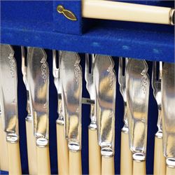 Suite of plated table cutlery for twelve covers including fish cutlery and servers, fruit knives and forks with mother of pearl handles, bone handled knives, carvers etc in an oak  three drawer cabinet with hinged lid W47cm 160 pieces