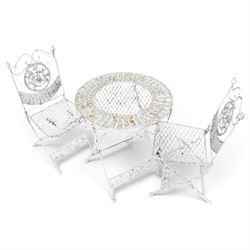 Three-piece French style white-painted wrought iron garden bistro set, comprising a circular folding table with latticework top and apron with scrolling foliate motifs (W70cm H80cm) and matching pair of chairs, with scrolling cresting rail and acorn finials over a scrolled foliate medallion, raised on lattice seat and folding X-frame base (W42cm H93cm)