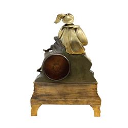 French-Louis XVIII  8-day mantle clock c1820, on a rectangular gilt metal base incorporating repeating cast leaf decoration on a pierced apron and bracket feet, surmounted with a cast brass figure depicting a reclining lady in 18th century dress, Parisian drum movement with a silk suspension and unglazed silvered dial, with Roman numerals and steel moon hands, dial pinned to a countwheel striking movement, sounding the hours and half-hours on a bell. With pendulum and key.
