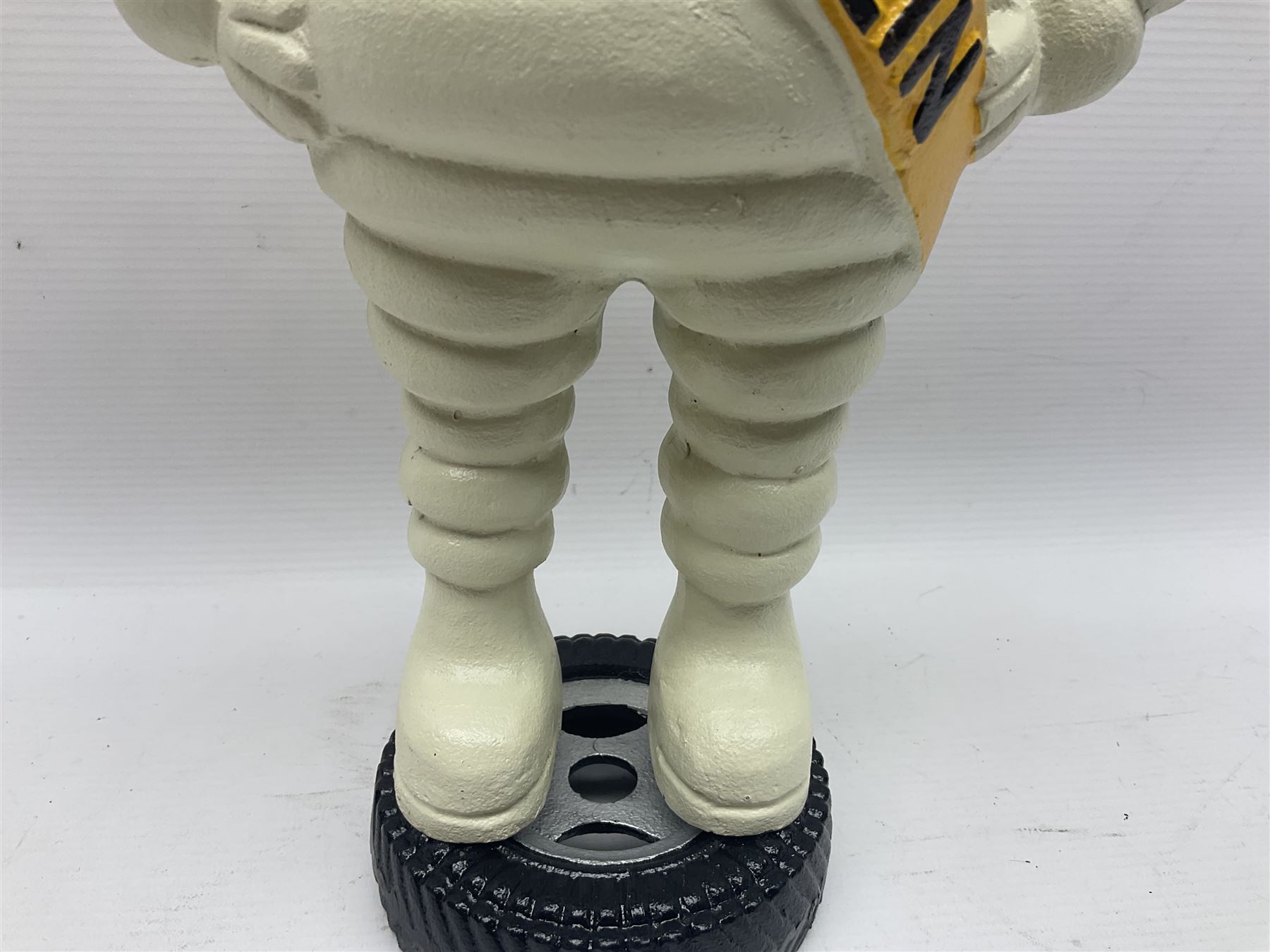 Cast iron figure of Michelin Man, stood on a tyre, H34cm 