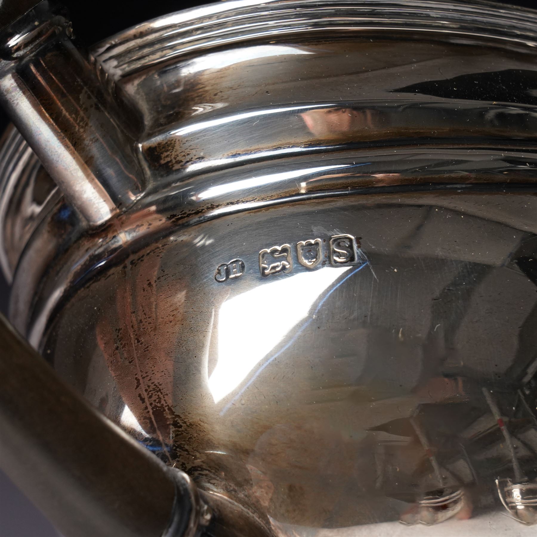 Silver three piece tea set of oval form, the teapot with ebonised handle and lift London 1913 Maker John Hunt and a pair of Victorian silver sugar tongs