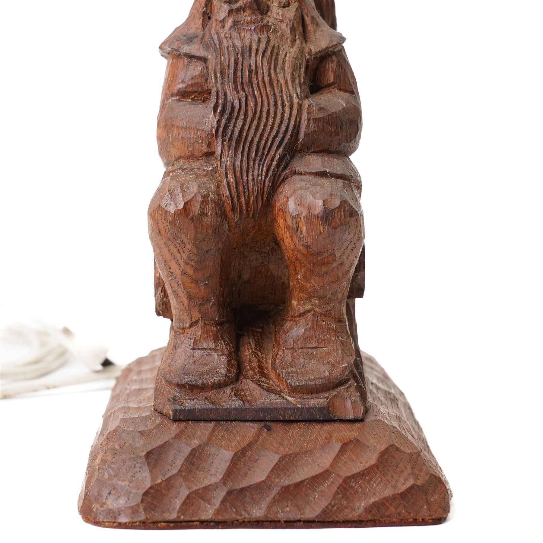 Gnomeman - an oak table lamp, with carved gnome figure seated on a log at the base of a tree stump, on a tooled base, by Thomas Whittaker of Littlebeck, H28cm excluding fitting