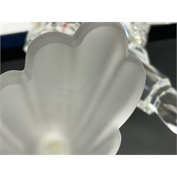 Swarovski Crystal Masquerade trilogy; 1999 Masquerade Pierrot, 2000 Columbine, 2001 Harlequin all with accompanying plaque, stand and original box, together with a glass display case with mirrored back and sides 