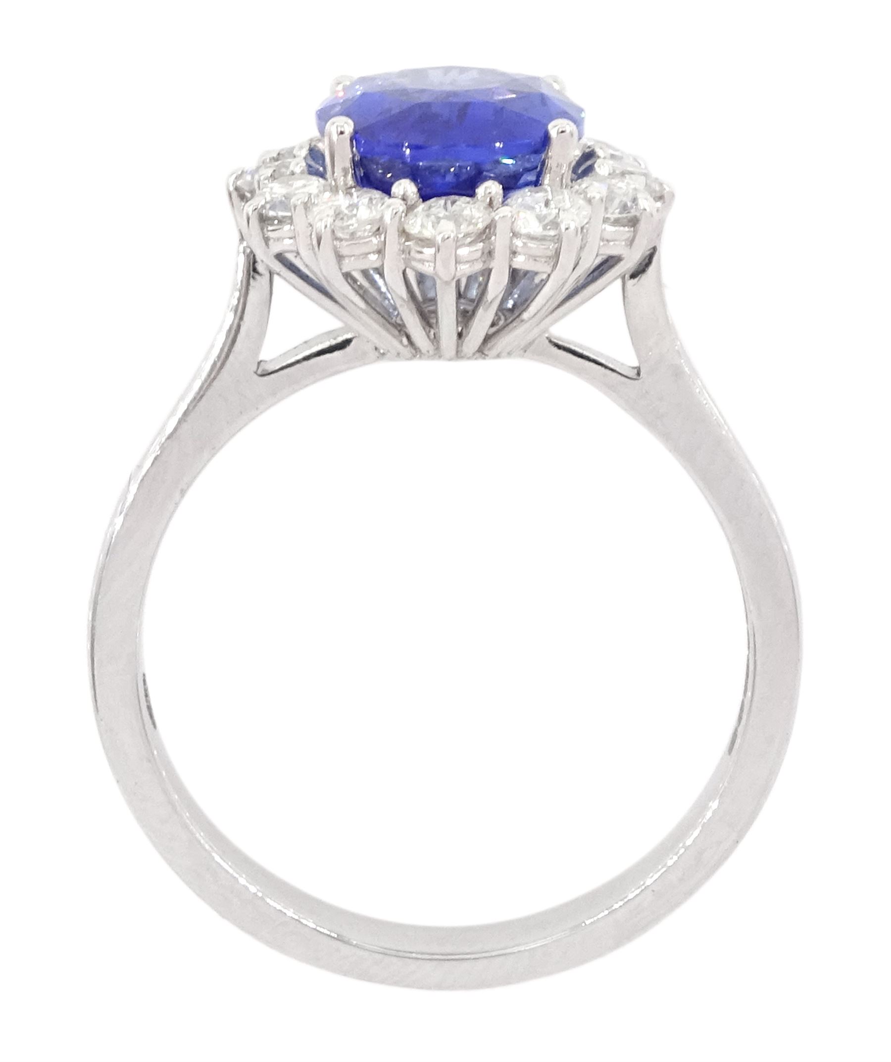 18ct white gold oval cut sapphire and round brilliant cut diamond cluster ring, hallmarked, sapphire approx 3.85 carat