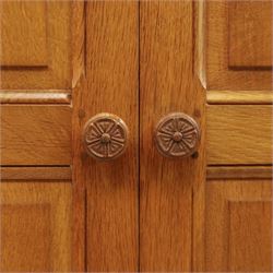 Beaverman - oak double wardrobe, enclosed by twin multi-panelled doors, Yorkshire Rose carved handles, the interior fitted with shelf and hanging rail, with signature carved beaver, by Colin Almack of Sutton, near Thirsk