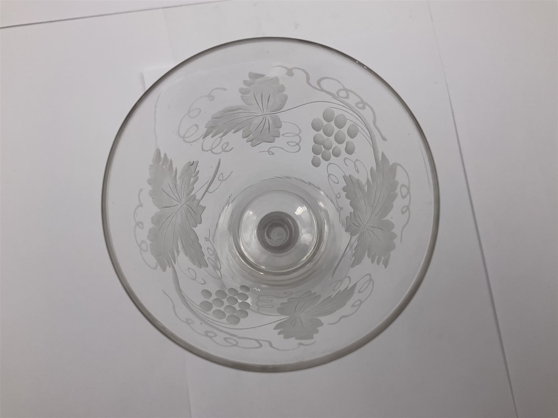 Set of three 18th century style wine glasses, each with funnel bowl etched with fruit vine, upon a double series air twist stem and circular foot, H17cm