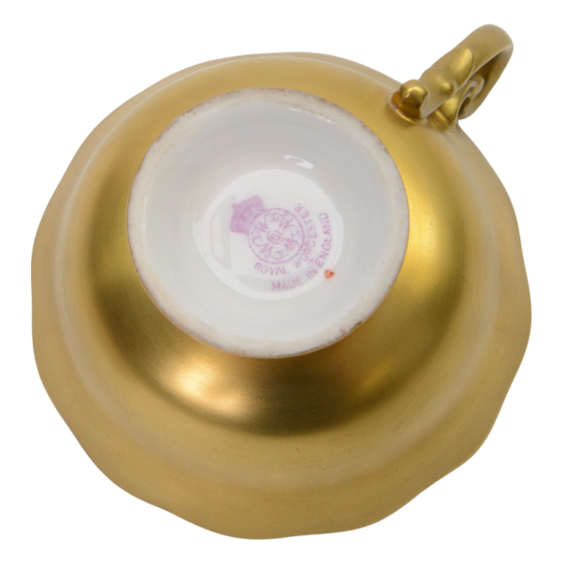 Royal Worcester fruit painted cabinet teacup and saucer, interior hand painted with apples, blackberry and cherries upon a mossy ground, the cup exterior and centre of saucer gilded, cup and saucer signed Rickells, each with puce coloured printed marks beneath, H7cm