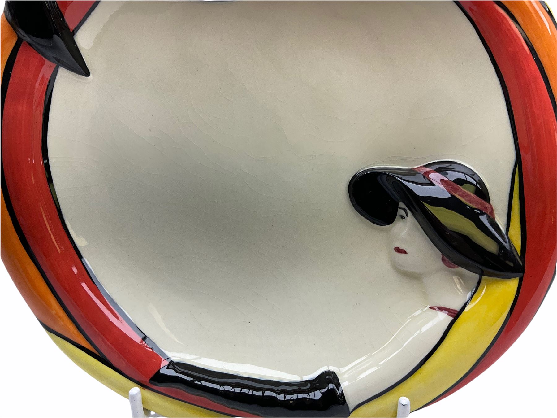 Lorna Bailey Old Ellgreave Pottery, comprising teapot in beach design, circular jar in house and path design, shell jug in Bridge and stream design, squat jug in Pagoda design and plate decorated with an Art Deco woman, all with printed and painted marks. 