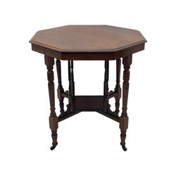 Victorian oak occasional table, octagonal top with bevelled edges, lower section fitted with a square undertier united by decorative shaped stretchers, on turned supports with castors