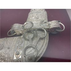 20th century silver Khanjar dagger from Oman, heavily decorated with filigree throughout, dome shaped pommel and waisted grip, the sheath with fastening rings, with miniature curved dagger accessory, housed in red lined glazed box frame, L38cm