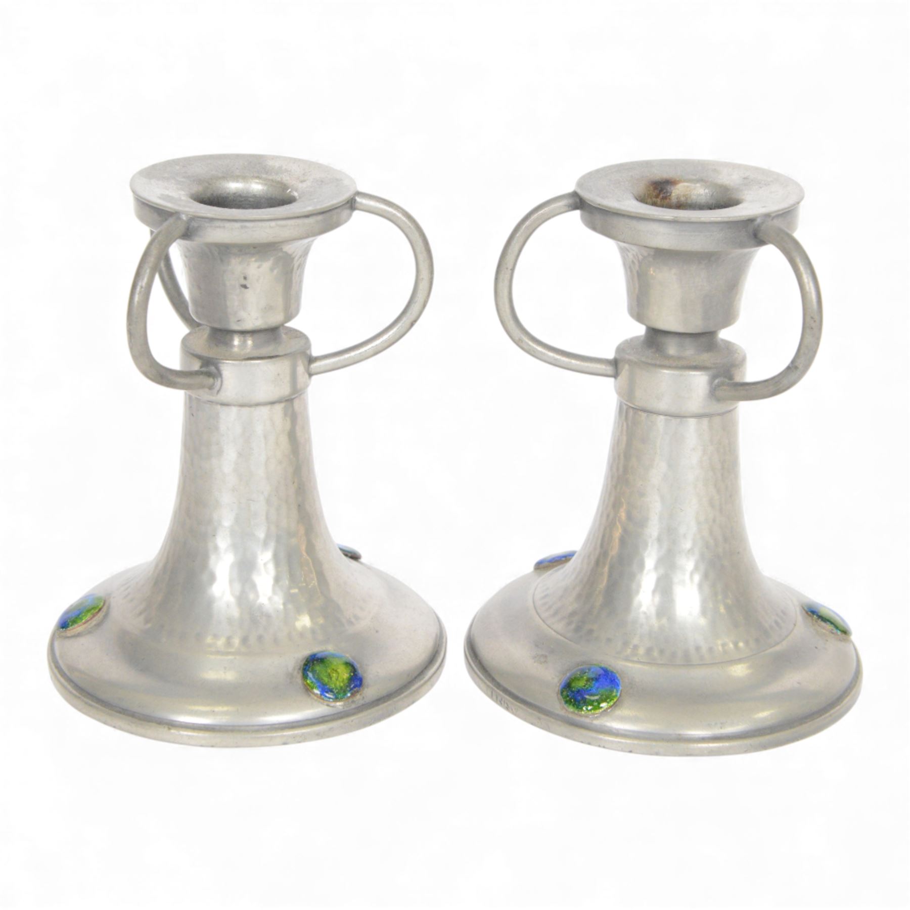 Pair of  Jugendstil hammered pewter candlestick each set with three blue and green enamel roundels, marked Germany beneath, H12cm
