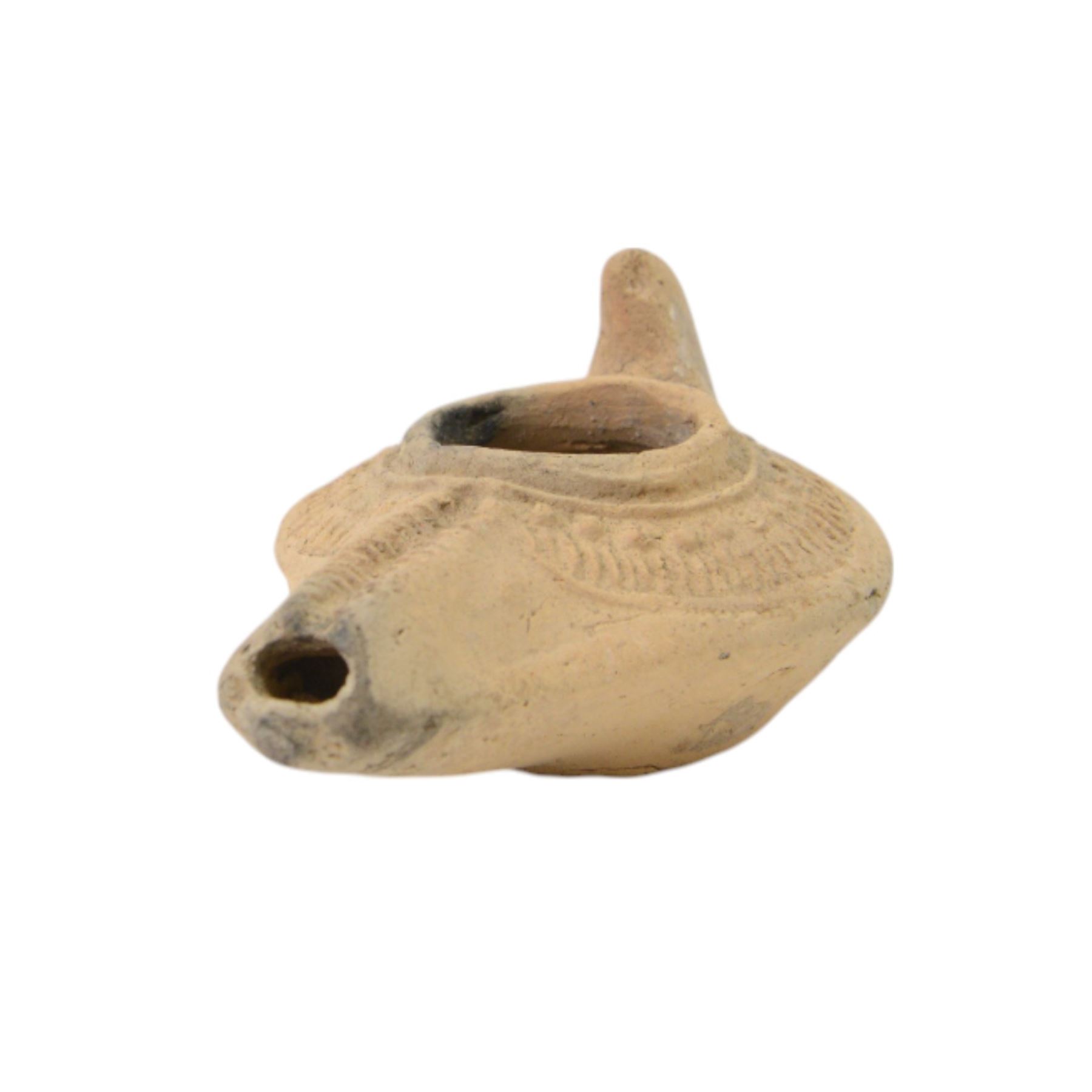 Antiquities; two decorative terracotta Byzantine oil lamps, 4th - 5th century, with decorative spouts, together with two similar examples