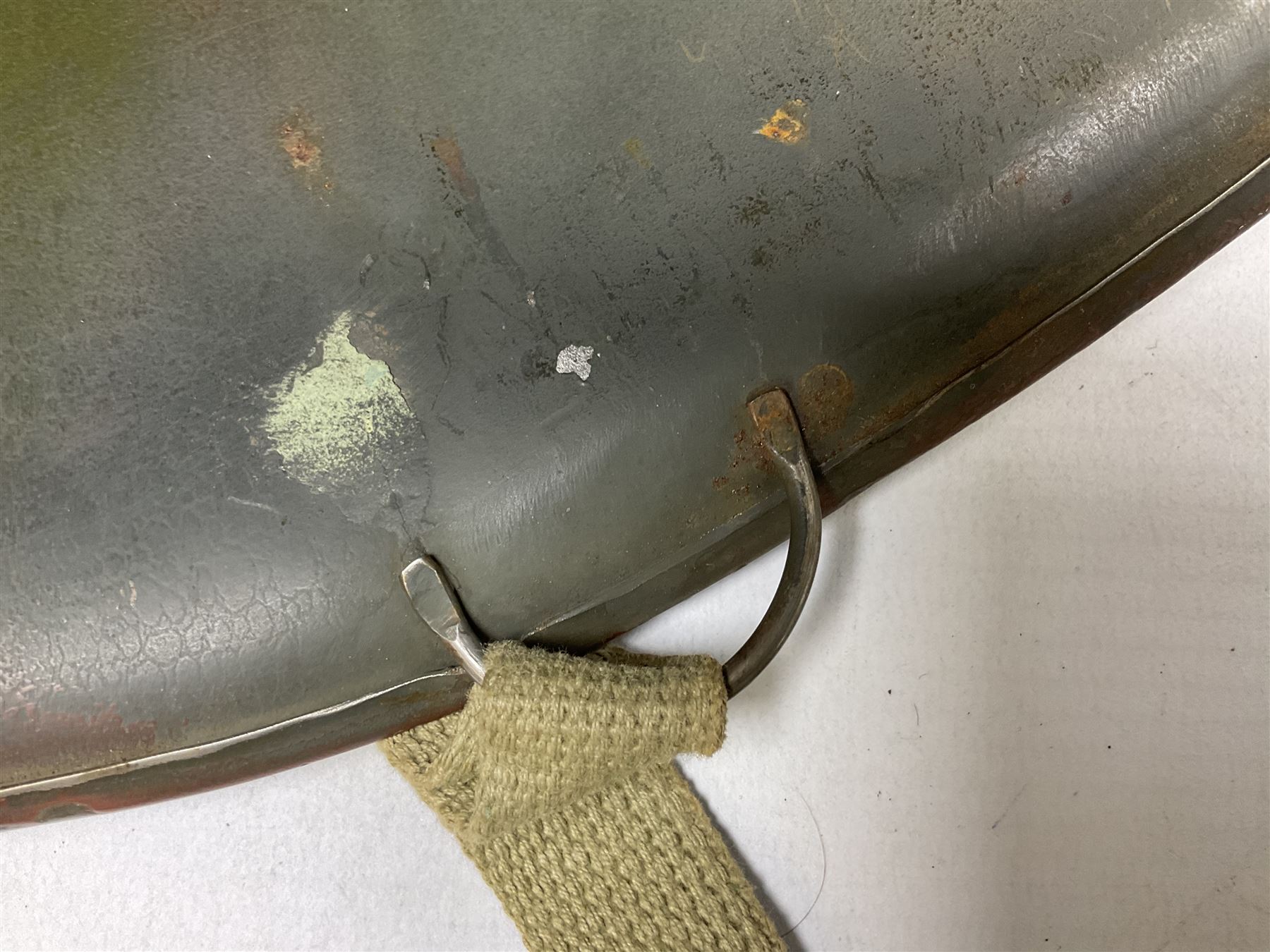 American first type paratrooper helmet with post-WW2 strap and D-rings and later 1944 liner bearing Firestone Tyre and Rubber Company mark; green textured finish