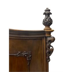 Early 20th century Italian walnut armoire wardrobe, the pierced and scrolling pediment carved with acanthus leaf detail, flanked by two scrolling cartouche with matching corbels below, the two panelled doors with applied carved rinceaux slips, with a central spiral turned upright, enclosing single shelf and hanging rail, raised on scroll feet