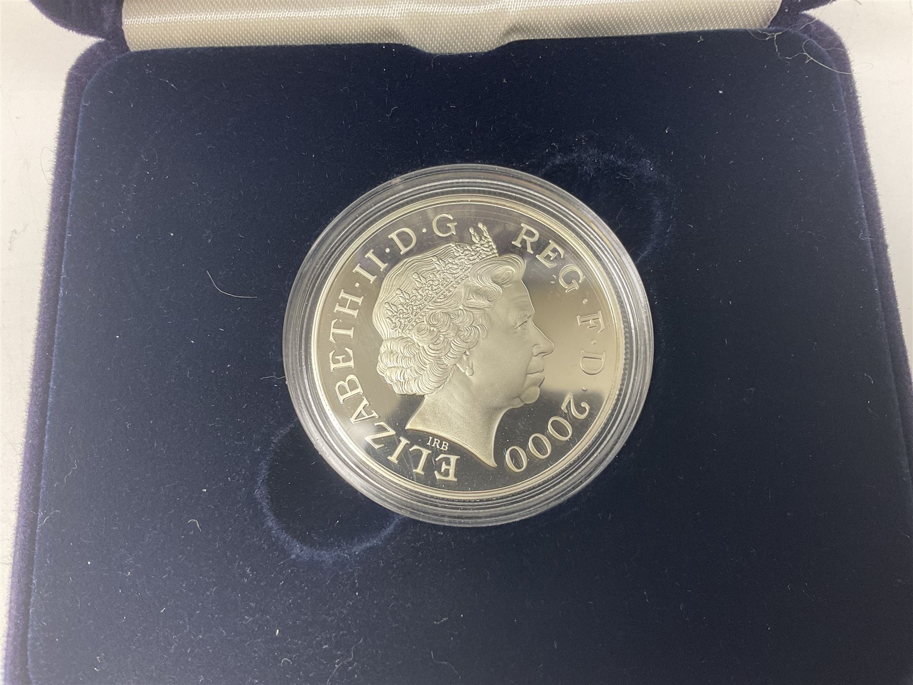 Queen Elizabeth II 2000 'The Queen Mother' silver proof five pound coin, 2000 'Millennium' silver proof five pounds, 2007 'Scouts' silver proof fifty pence, Tristan Da Cunha 2014 9ct gold 1 gram gold one crown coin, all cased with certificates and a 'Prince Charles 60th Birthday Commemorative Coin Cover' containing a 2008 silver proof five pound coin in folder (5)