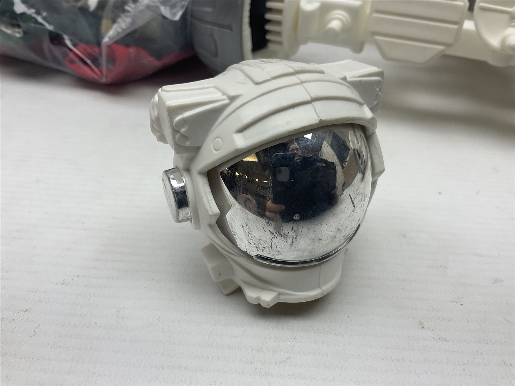 Action Man - large collection of 1960s and later figures and accessories including Spaceman with ATLRV vehicle; two figures marked 'Made in England by Palitoy under licence from Hasbro 1964'; twenty-five assorted weapons; radio backpacks; kit bags; twenty-one pairs of boots; football boots and snow shoes; metal diver's boots and three pairs of flippers; two pairs of jackboots; roller skates; various tunics, trousers, flying suits, jumpers, belts etc; twenty helmets, berets, busby, kepis, submariner etc; and quantity of other accessories