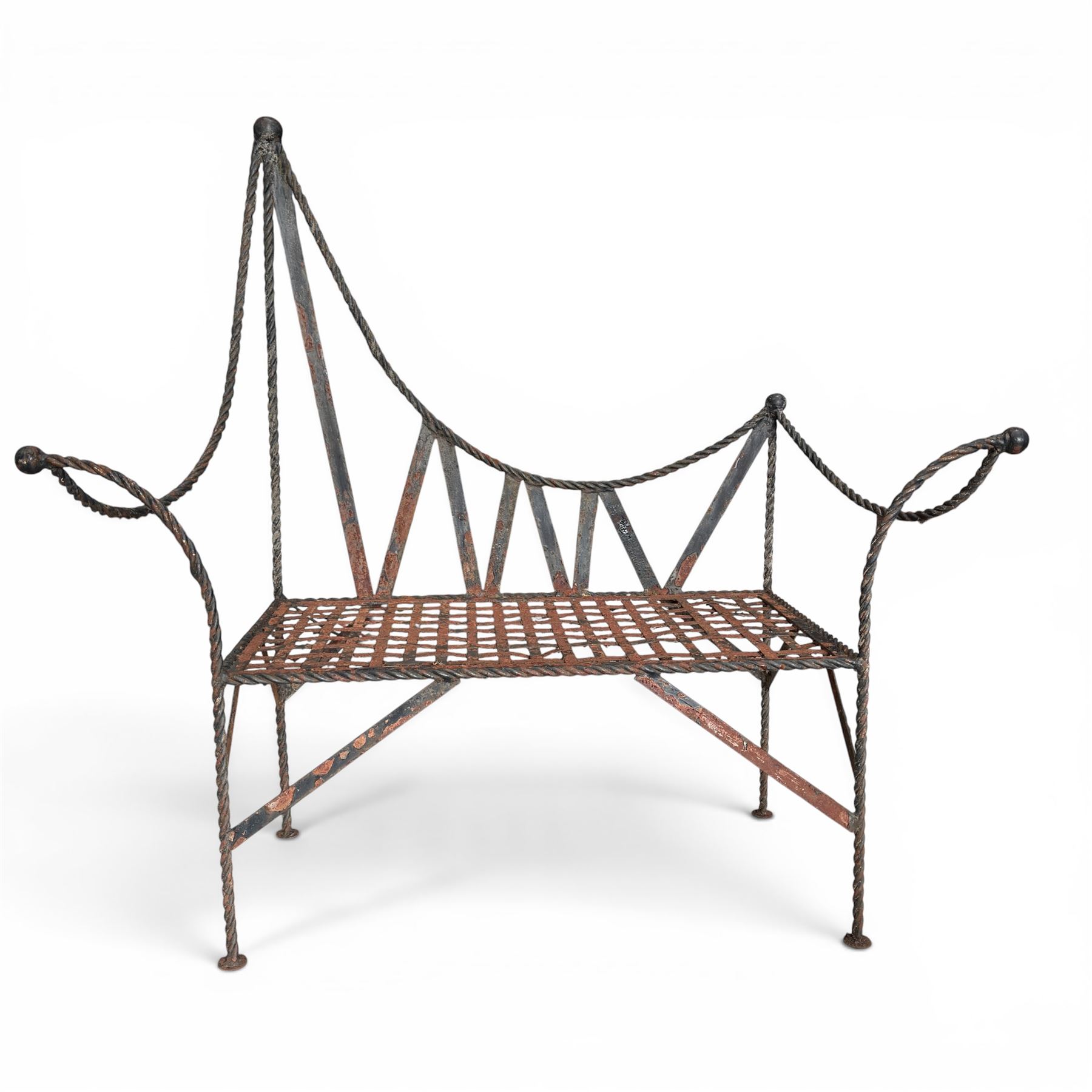 Victorian design wrought iron garden bench, with asymmetrical rope-twist frame, arched back and sides over out-swept arm terminals with ball finials, flanking a lattice seat, in antique black-painted weathered finish