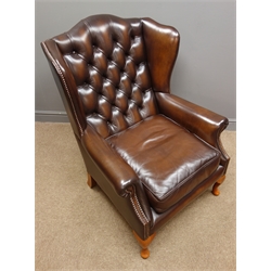  Georgian style wingback armchair and matching stool, upholstered in deeply buttoned brown leather, cabriole legs  