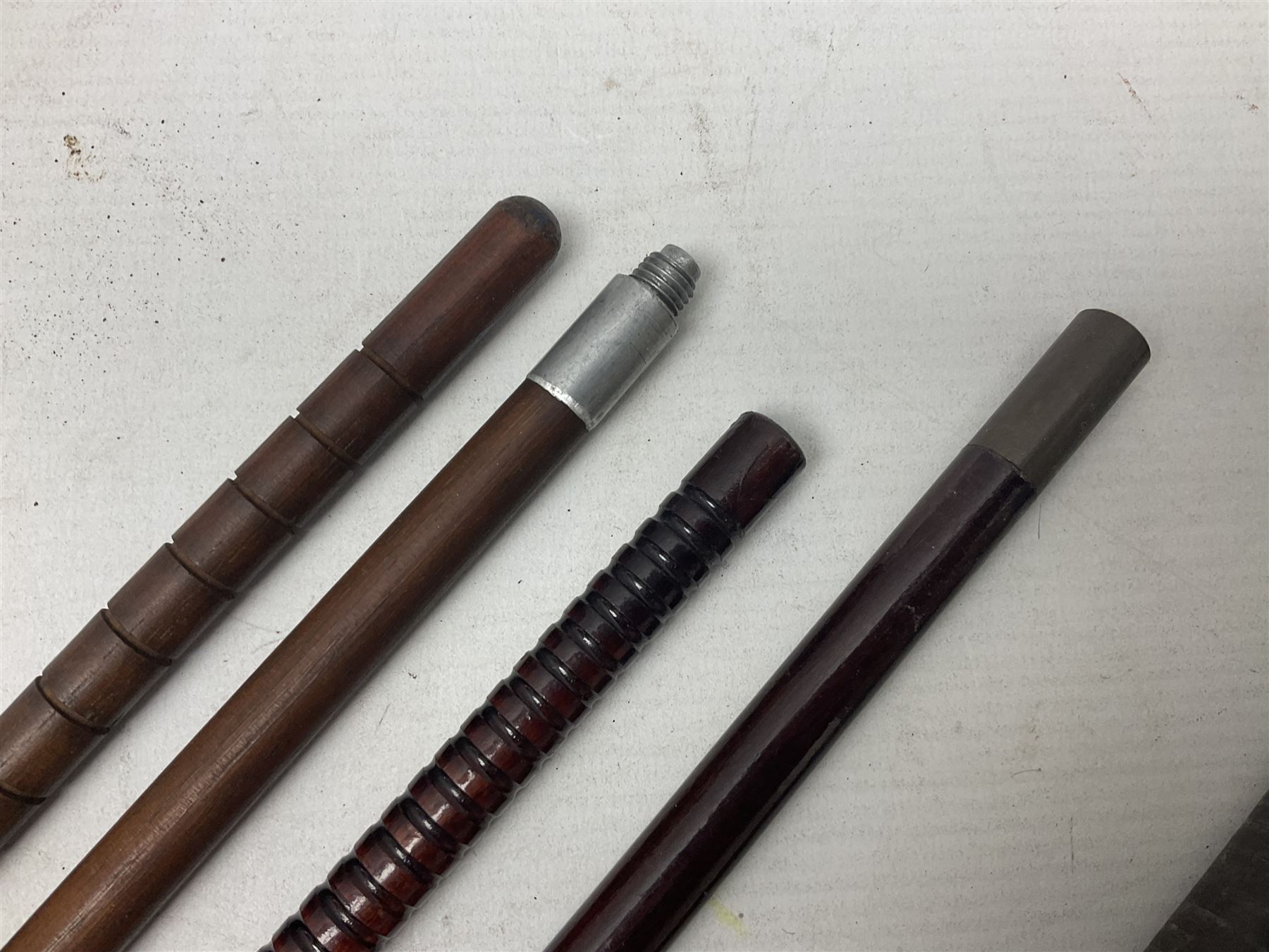 George V 1897 pattern Infantry officers sword, the 82cm single fullered blade with traces of etched detail and George V crown cipher, the ricasso marked Hawksworth Sheffield, pierced half basket hilt with George V cypher, wire-bound fish-skin grip with brass pommel and backstrap; in leather scabbard L102cm overall; together with two sectional gun cleaning rods; swagger stick made of leather strips etc