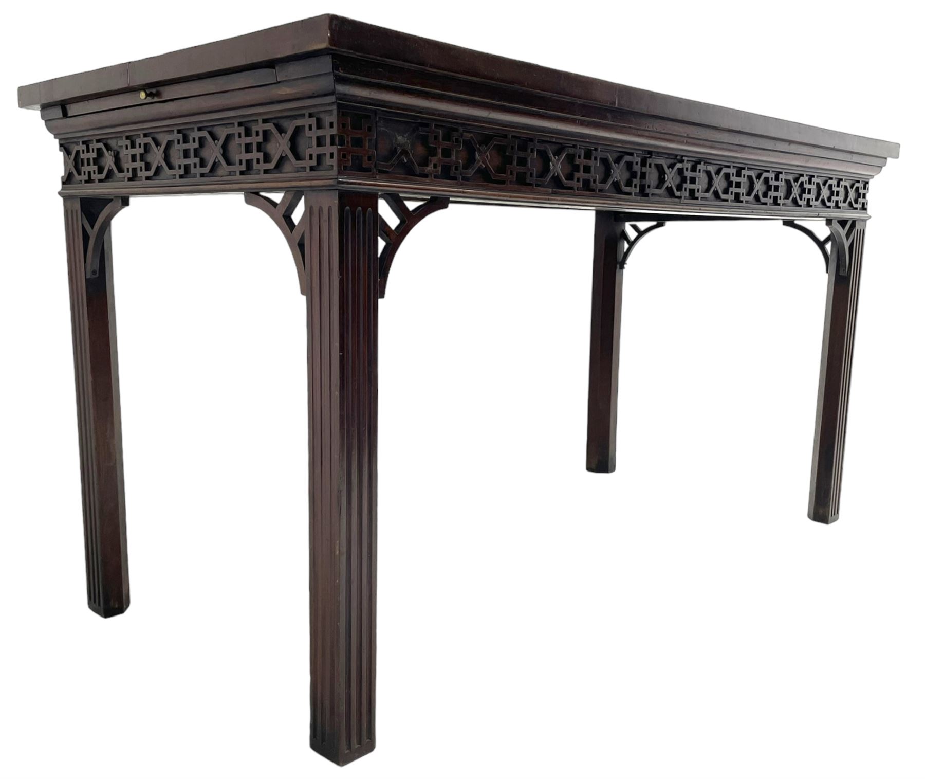 In the manner of Thomas Chippendale - early 19th century mahogany serving table, rectangular crossbanded top with boxwood stringing, the frieze with upper moulding over applied geometric fretwork, the left-hand side fitted with slide, on fluted square supports with inner chamfer 