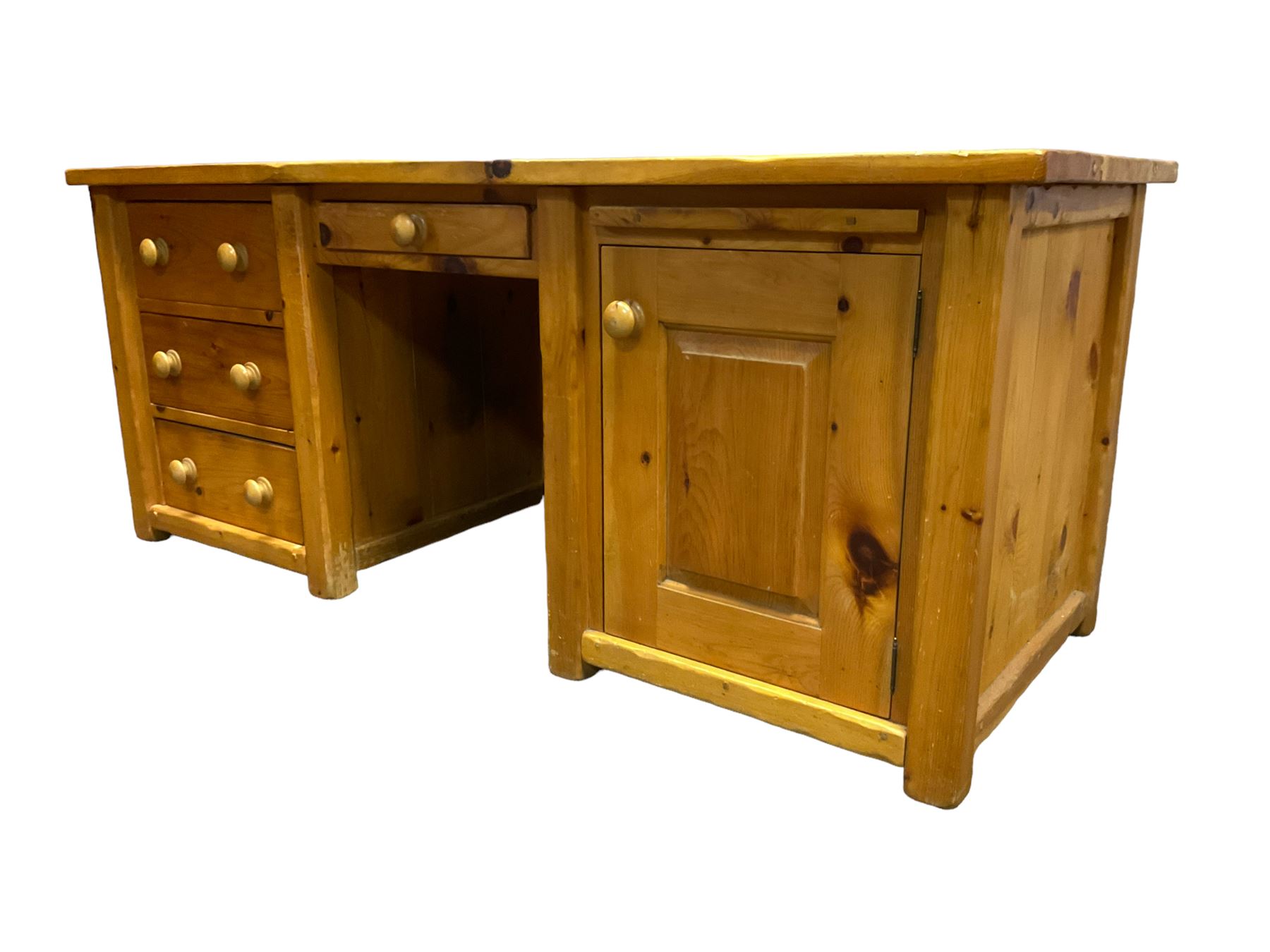Large pine desk, rectangular top over four drawers, slide and panelled cupboard