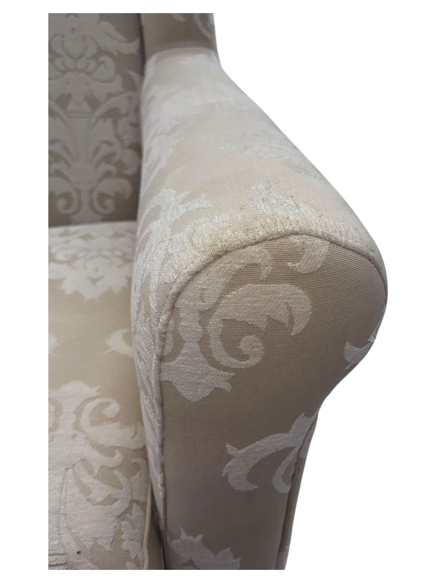 Chatsworth hardwood-framed armchair upholstered in cream  damask, with rolled arms and cushioned seat, raised on square tapered feet
