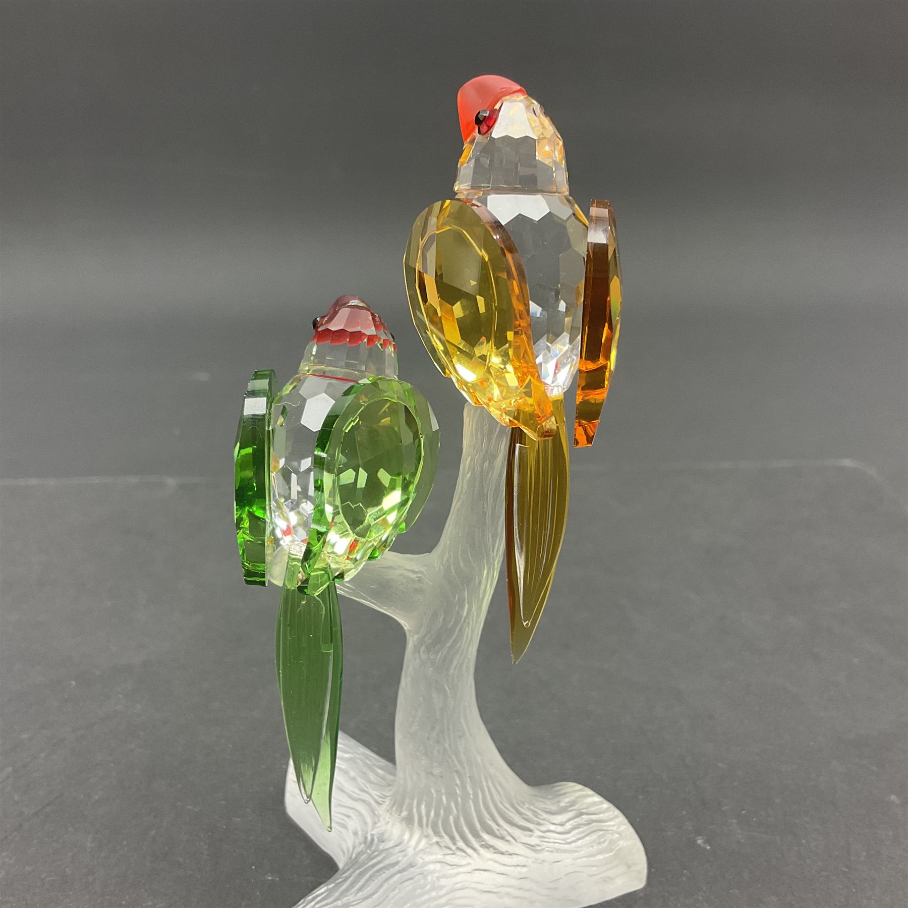 Three Swarovski Crystal bird figures, comprising Toucan, pair of puffins and pair of parrots on a branch, tallest H10cm