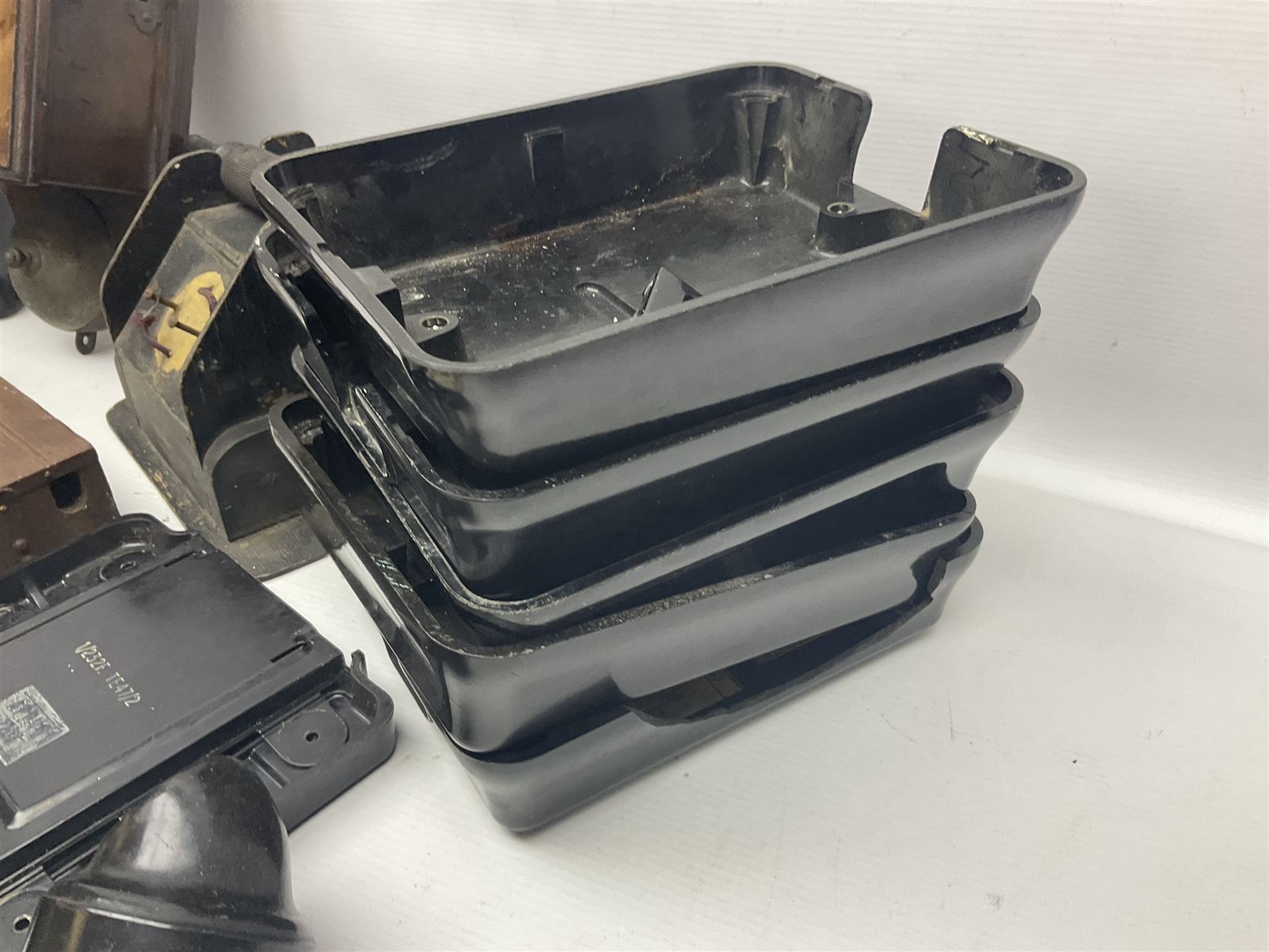 Collection of phone headsets, including GPO bakelite examples, together with other telephone parts 