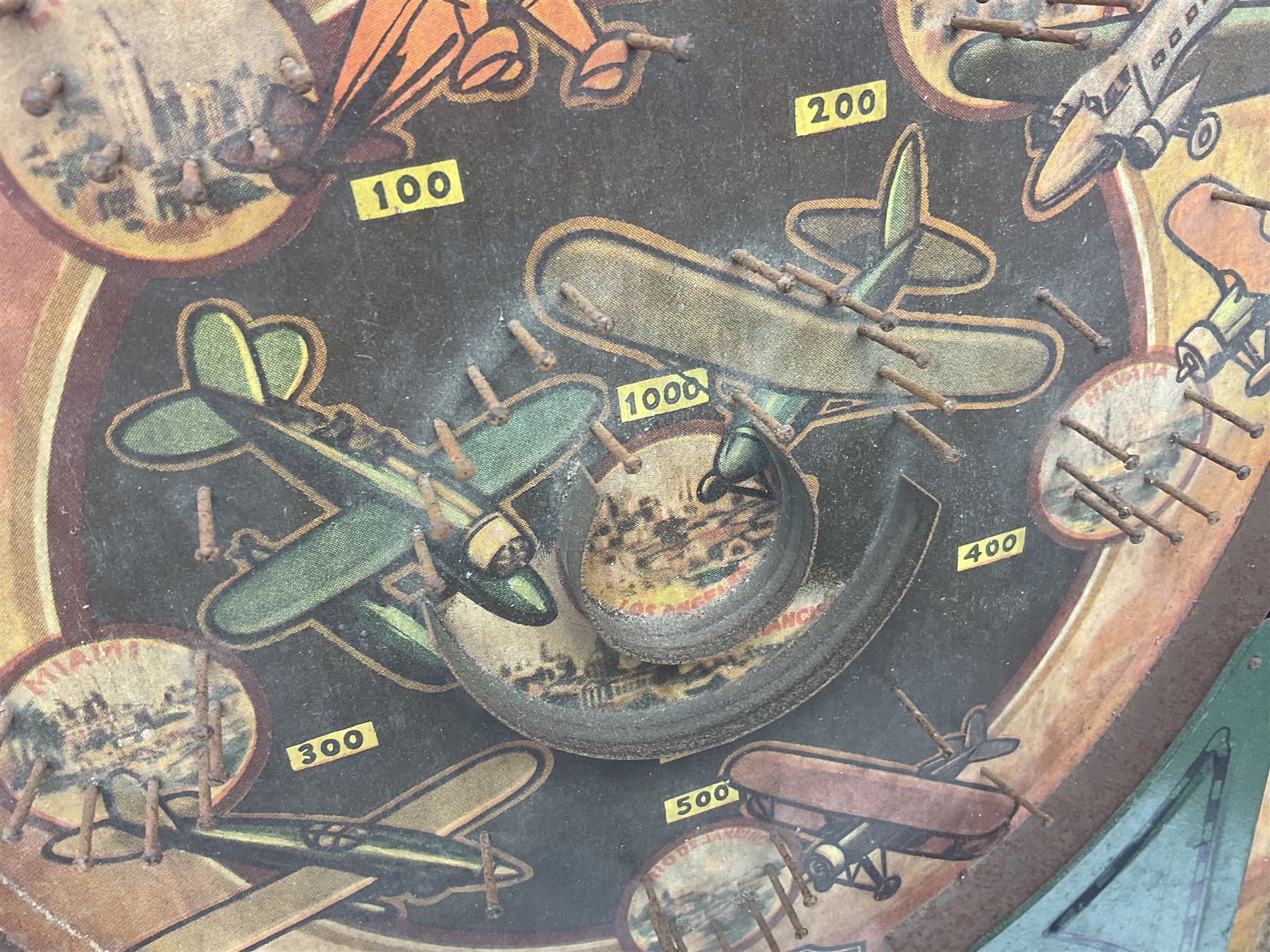 1934 Lindstrom's 'Airways' tin-plate bagatelle game by Lindstrom Tool and Toy Company Bridgeport Conn., the decorative bagatelle board depicting Lindstrom's epic airway routes; with wooden peg and quantity of balls H61cm