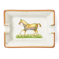 Hermès - set of four miniature porcelain ashtrays, each decorated with a horse in differing blanket, with gilt and coloured borders, in contrasting colour with various horse-coats, in original fitted box