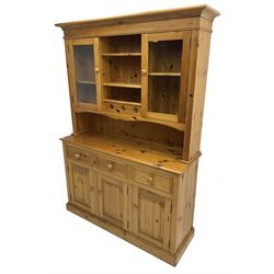 Traditional pine dresser, the rack fitted with two shelves flanked by glazed cupboards, the base with three drawers over three panelled cupboards
