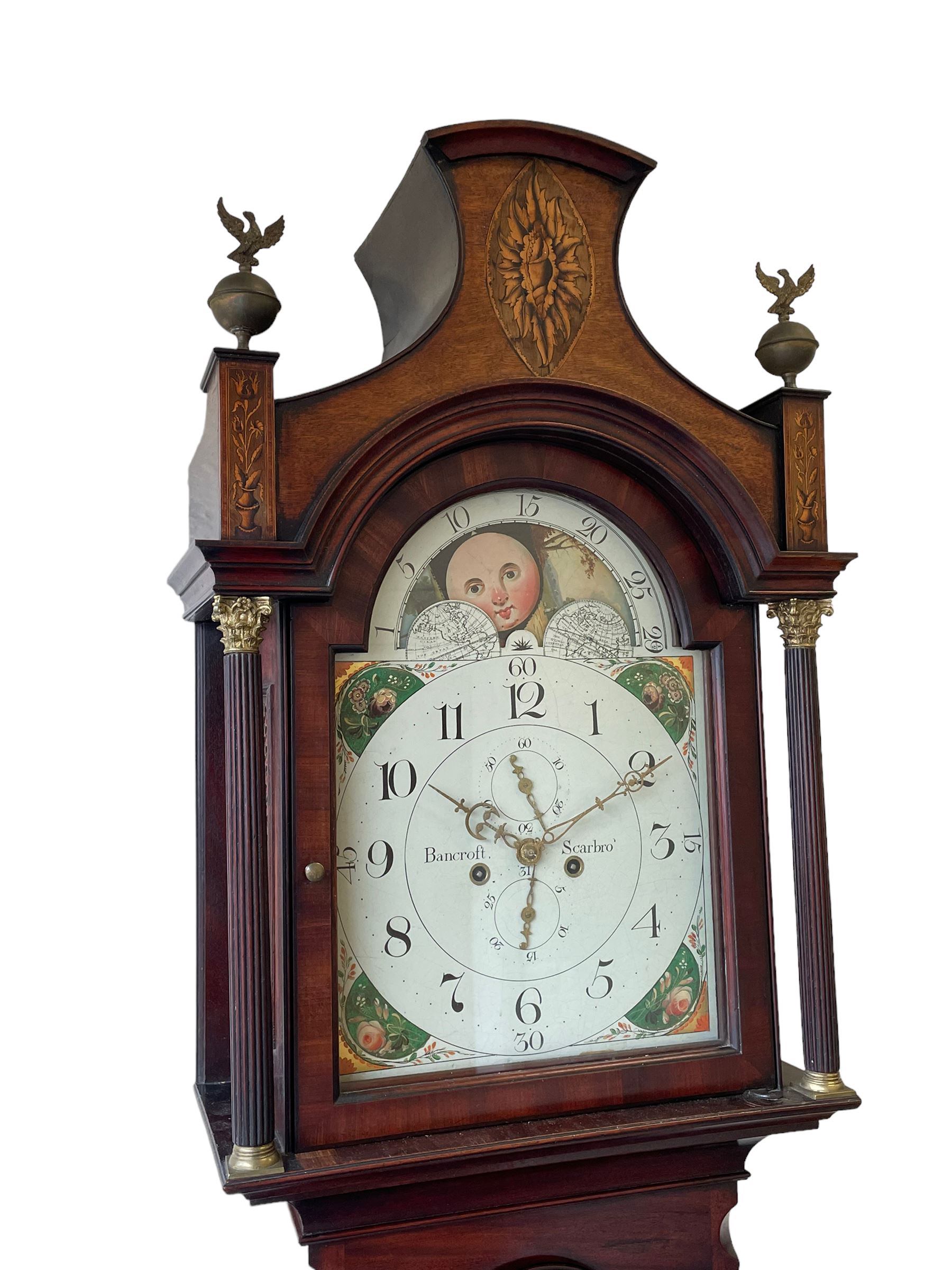 John Bancroft of Scarborough - a fine late George III 8-day mahogany longcase clock, with an elaborate pagoda pediment, brass ball and eagle finials and oval conch shell inlay, break arch hood door flanked by reeded pilasters with brass Corinthian capitals, trunk with inlaid canted corners and a break arch trunk door with 