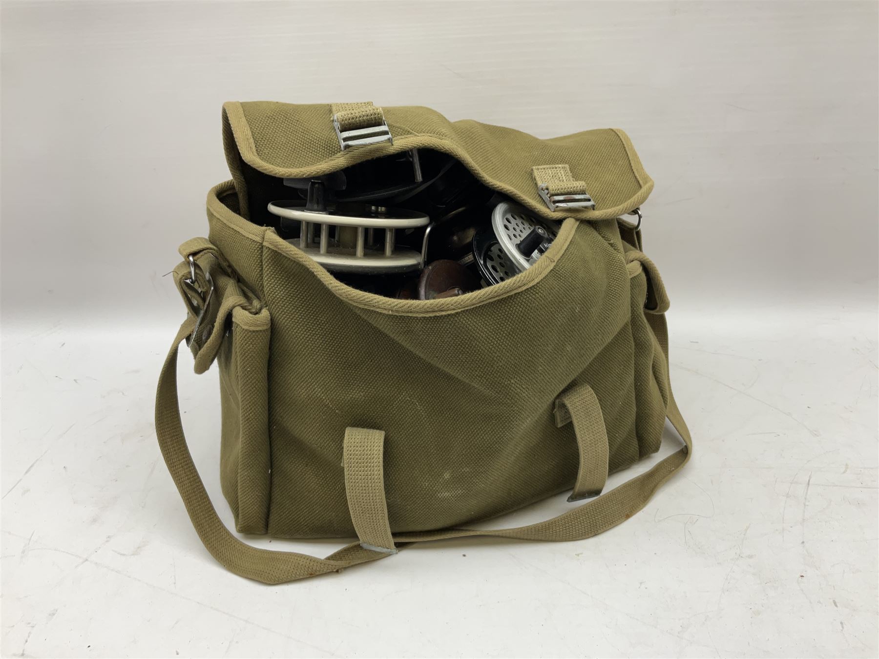 Fishing tackle, including 'The Gnat' fly reel, Alvey 4 1/2 inch reel, Paramount 4 1/2 inch reel, other fishing reels, various fishing flies and other similar items in a carry bag 